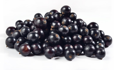 Heap of fresh black currant close up on a white