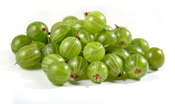 Heap of fresh green gooseberry close up on a white