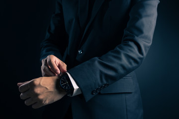 Businessman checking time from watch