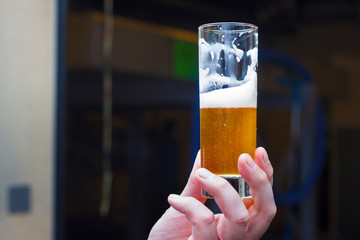 Belgian lambic (geuze) beer glass in hand.