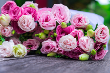 Beautiful bouquet of pink roses on wood background, outdoor