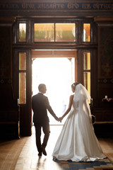 beautiful and young couple on wedding ceremony in church