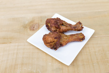 Deep fried chicken leg on wooden table