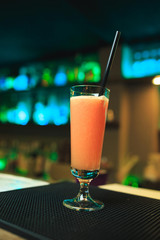 Orange fresh juice in steamware on rack