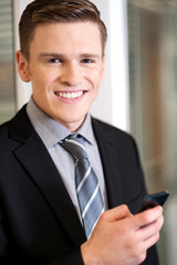 Fototapeta premium Businessman sending message in mobile phone.