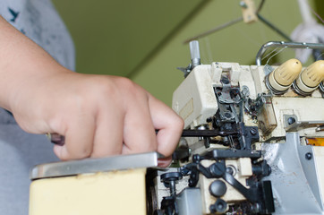  mechanic repairing industrial sewing machine
