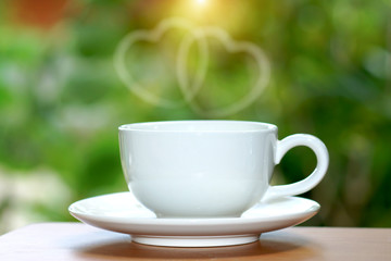 White cup coffee with nature background.
