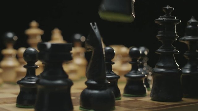 Player moves black runner. Board makes a ninty degree rotation. Shot on black background in studio. Red Epic camera fifty frames per second.
