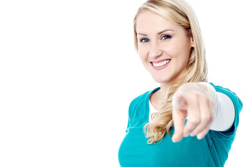 Fototapeta premium Attractive young lady pointing you out