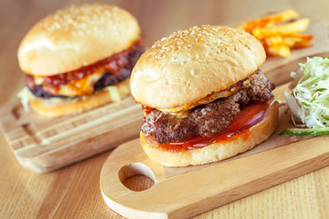 home made burgers on wooden background