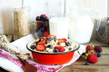 Healthy oatmeal porridge with berries and nuts for breakfast