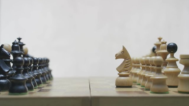 Two players prepering chess pieces before the game. White background.
