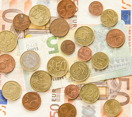 close up of euro currency. coins, banknotes and calculator