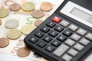 close up of euro currency. coins, banknotes and calculator