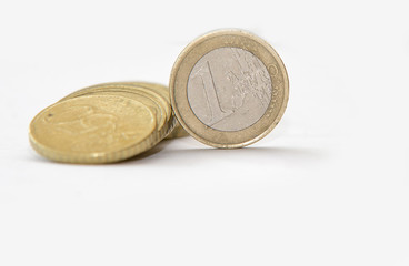 close up of euro currency. one euro coin on white background