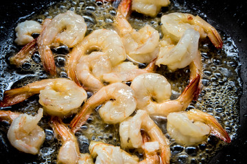 Shrimp fried in a pan prepare to fill other condiment