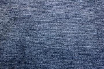 Jeans texture dark blue and white denim natural pattern fabric clothes background with diagonal lines and stitches