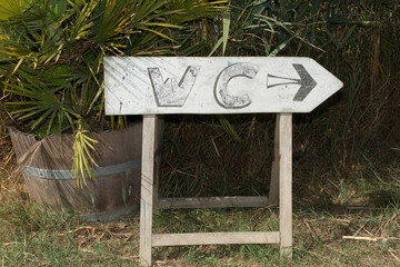 Toilet or restroom sign on wood
