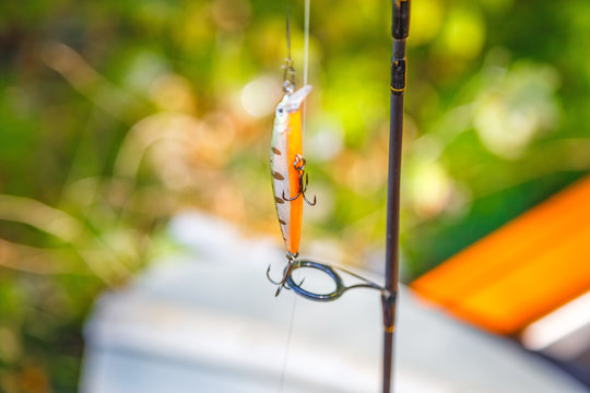 Close up wobbler at paddles background. Outdoor scene. Fishing concept.