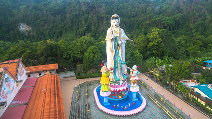 Quan Yin the Chinese goddess of mercy and compassion. the statue of Guan Yin, the highest in the country. the Chinese style building beside