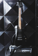 electric guitar and classic amplifier on a dark background