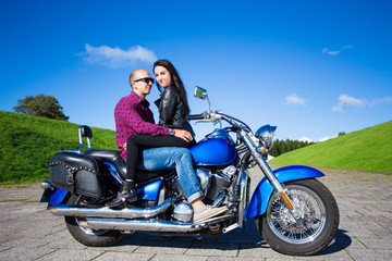 Fototapeta na wymiar lovely couple sitting on retro motorbike