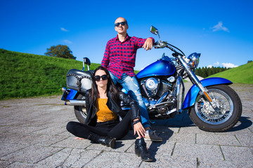 Fototapeta na wymiar young couple posing with retro motorbike