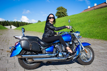 Naklejka na ściany i meble young sexy woman riding on vintage motorcycle