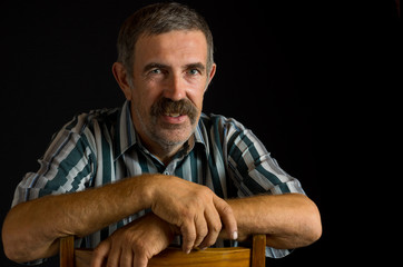 Portrait of smiling Ukrainian peasant in low key