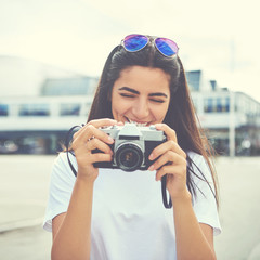 Laughing young woman checking the viewfinder