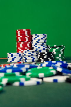 Stacked Poker Chips on green background