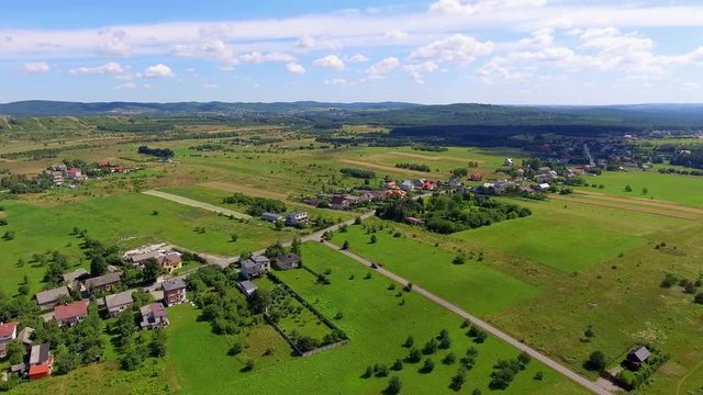 Rural landscape with green hill and blue sky in Poland. View from above.