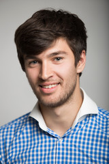 Obraz premium a large portrait of a happy young man in a plaid shirt