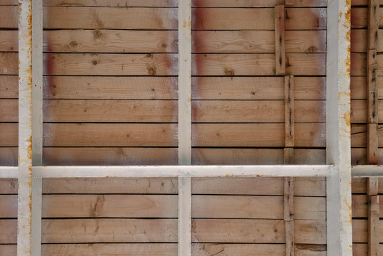 Bottom view of wooden board-walk on metal joists.