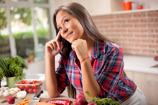 portrait of young  asian beautiful woman at home in kitchen