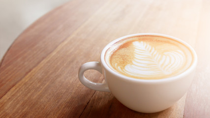Cup of Coffee latte art or cappuccino on wood table background