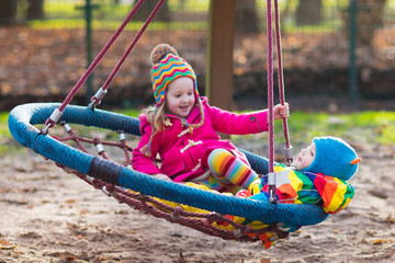 Kids on playground swing