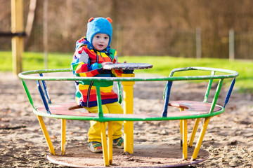 Little boy on playground in autumn