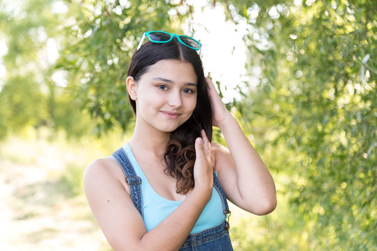 Teen girl standing on wood background