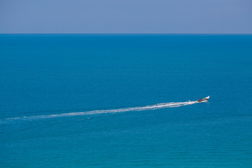 The boat in the azure ocean