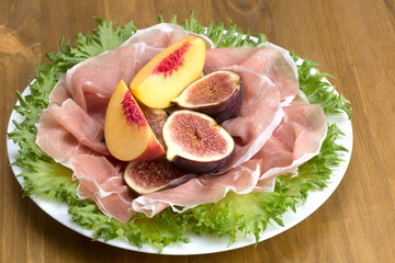 Prosciutto served with figs and peaches