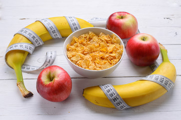 Healthy breakfast: cornflakes bananas and apples.