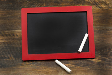 Empty Chalkboard wood frame with chalks and copy space
