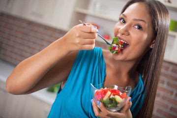 beautiful young Asian women eating a salad