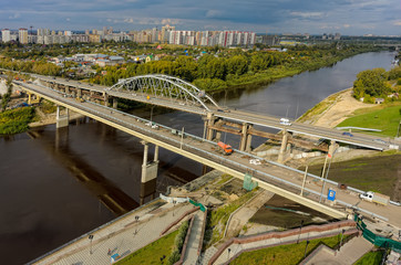 Tyumen, Russia - September 3, 2015: Aerial view of Tura river and bridge on Chelyuskinskaya street. Nearby there is construction of new one.