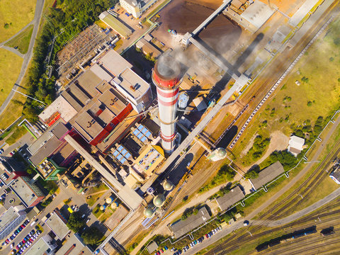 Aerial view of modern combined heat and power plant. Fuming chimney with sulphur removal unit. Heavy industry from above. Power and fuel generation in Czech Republic, European Union