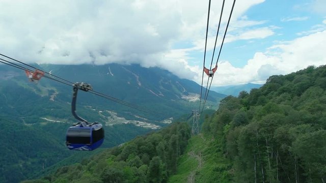 cabin of ropeway passes over mountains around Rosa Khutor Alpine Resort
