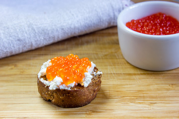 Bruschetta with ricotta cheese and red caviar