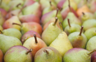 pears on the counter market as background