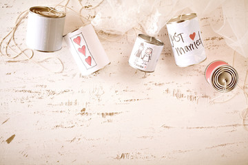 Scribbled love and marriage symbols on metal cans